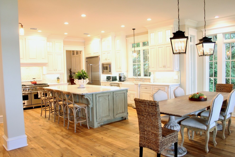 This is an example of a kitchen/dining combo in Other with beige walls, light hardwood floors and no fireplace.