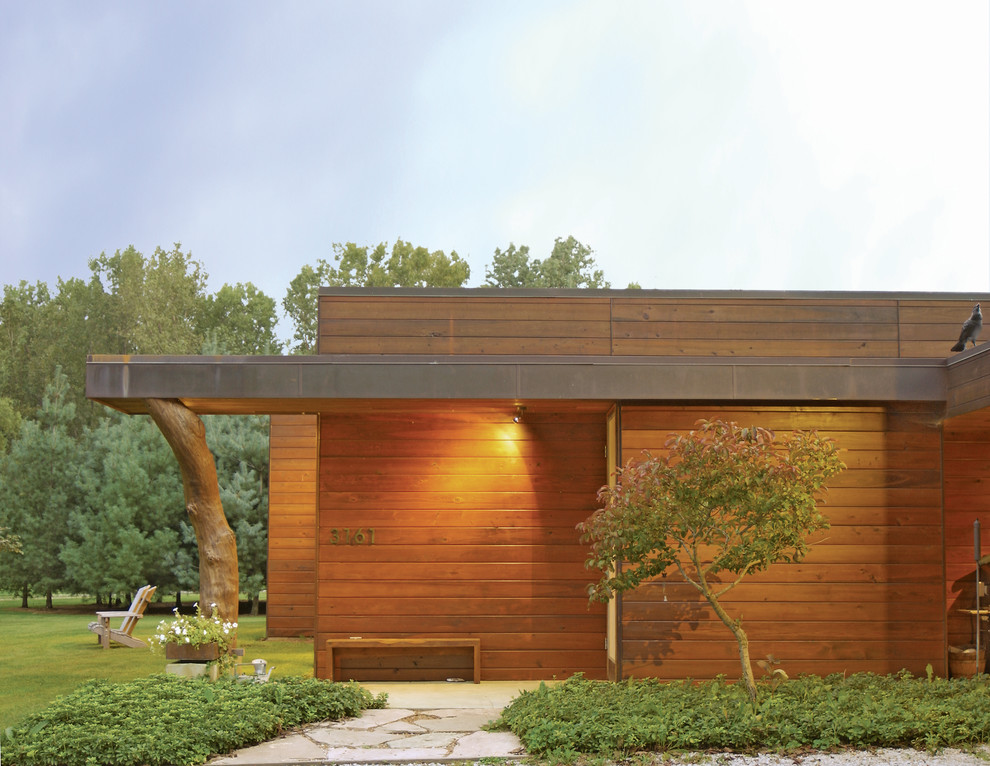 Design ideas for a modern one-storey brown exterior in Chicago with wood siding and a flat roof.