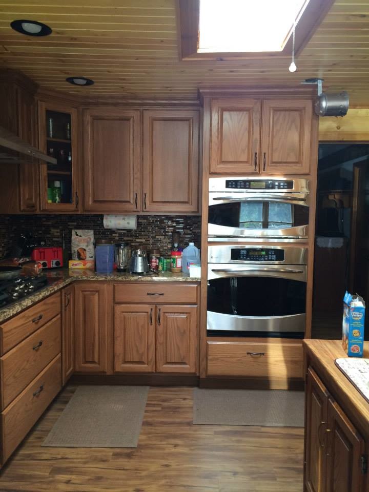 Inspiration for a medium tone wood floor kitchen remodel with medium tone wood cabinets and stainless steel appliances