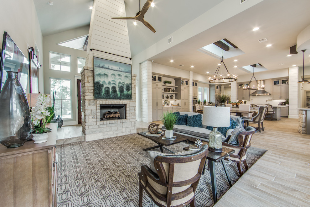 Design ideas for a large country open concept family room in Dallas with grey walls, porcelain floors, a standard fireplace, a stone fireplace surround and beige floor.