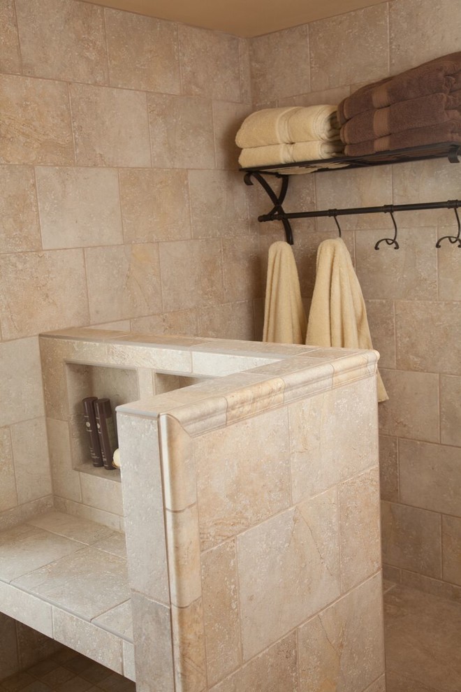 Photo of a large traditional master bathroom in Milwaukee with shaker cabinets, medium wood cabinets, an alcove shower, beige tile, ceramic tile, yellow walls, ceramic floors, a drop-in sink, granite benchtops, beige floor and a hinged shower door.