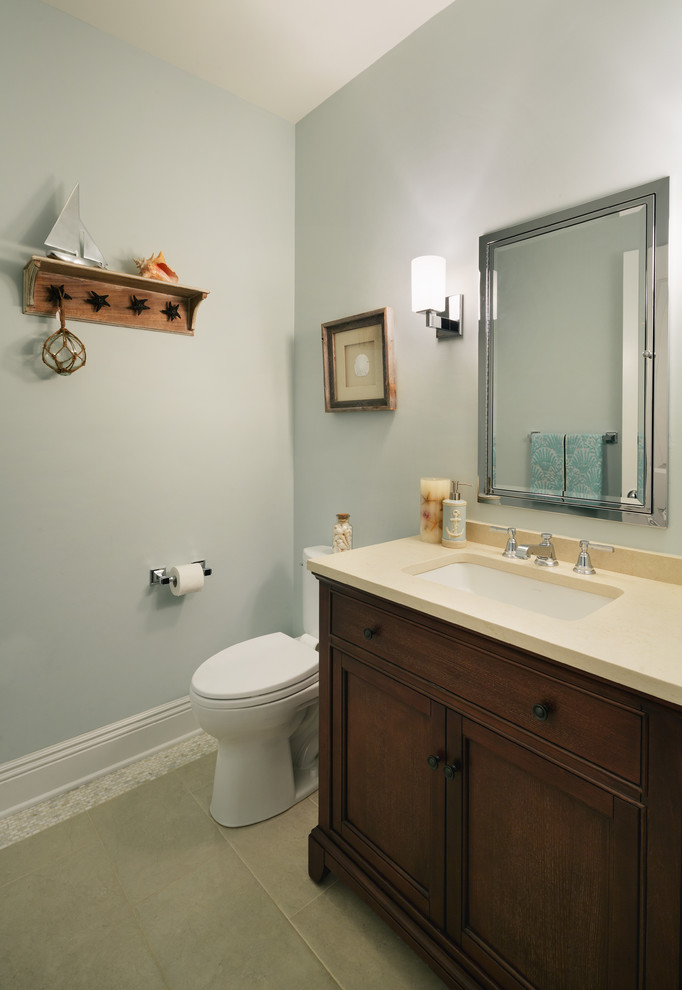 Design ideas for a mid-sized transitional powder room in New York with an undermount sink, recessed-panel cabinets, dark wood cabinets, engineered quartz benchtops, a one-piece toilet and blue walls.