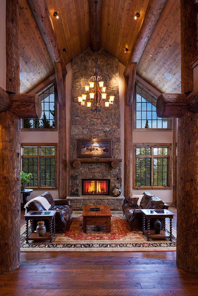 This is an example of an expansive country open concept living room in Other with a standard fireplace and a stone fireplace surround.