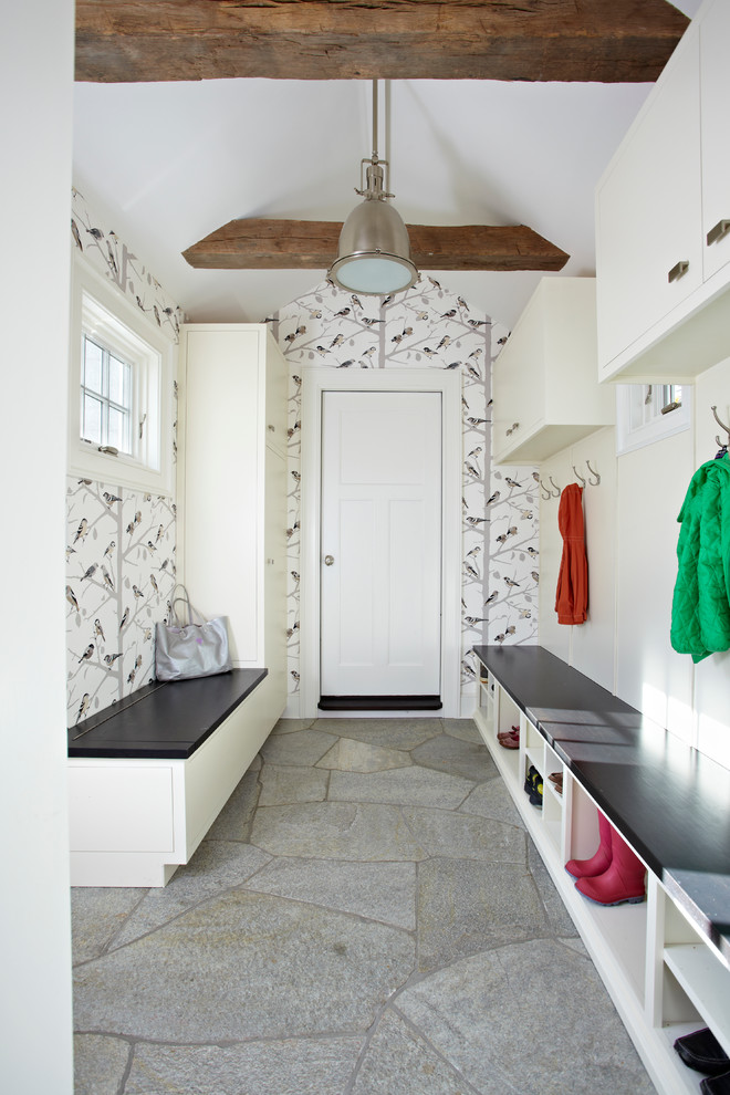 Transitional mudroom in New York with a white front door and grey floor.