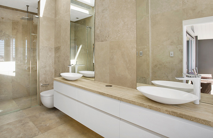 Large modern bathroom in Sydney with white cabinets, an open shower, marble, marble floors, marble benchtops, brown floor and a hinged shower door.