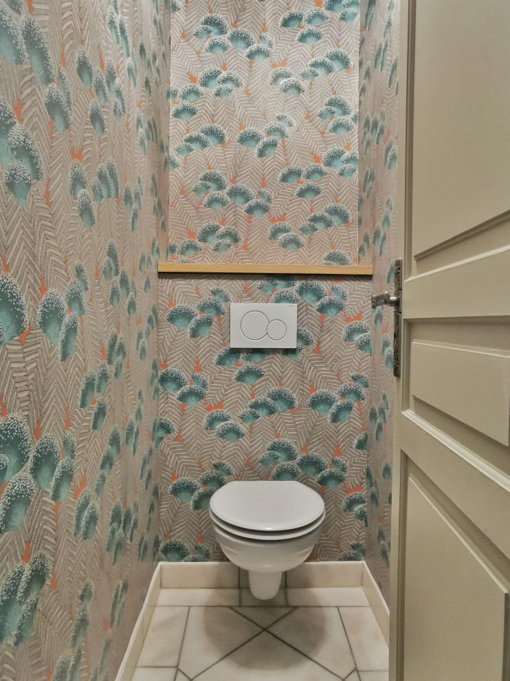 Photo of a small world-inspired cloakroom in Paris with a wall mounted toilet, marble flooring, beige floors and wallpapered walls.