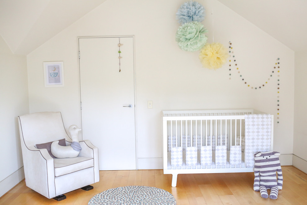 Inspiration for a mid-sized contemporary gender-neutral nursery in Sydney with white walls and light hardwood floors.