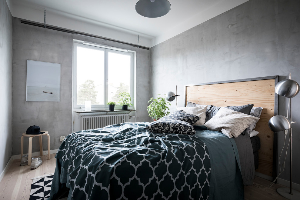 Photo of a scandinavian master bedroom in Stockholm with grey walls, light hardwood floors, beige floor and no fireplace.