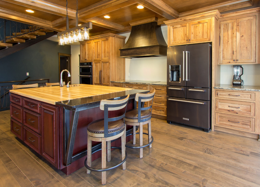 Open concept kitchen - rustic brown floor open concept kitchen idea with an undermount sink, flat-panel cabinets, medium tone wood cabinets, quartz countertops, stainless steel appliances and two islands