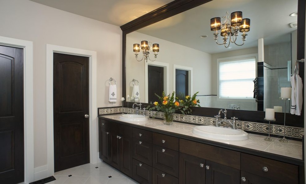 Freestanding bathtub - large transitional master multicolored tile and ceramic tile marble floor and white floor freestanding bathtub idea with recessed-panel cabinets, dark wood cabinets, beige walls, a drop-in sink, marble countertops, a hinged shower door and beige countertops