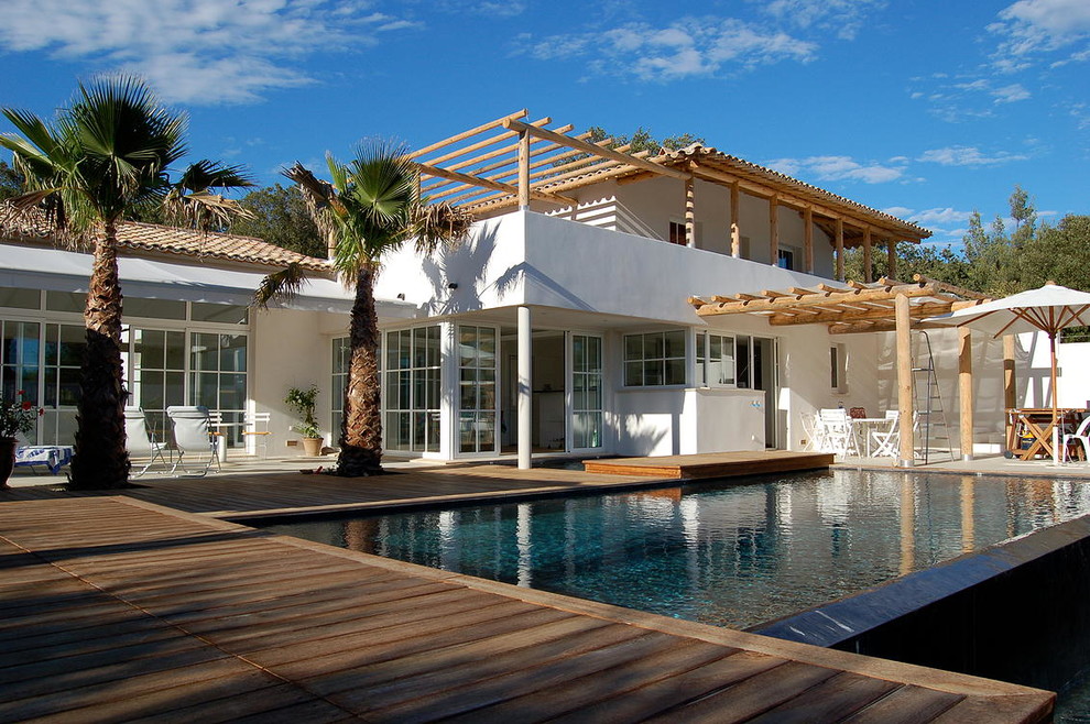 Inspiration for a large beach style two-storey white exterior in Marseille with a hip roof.