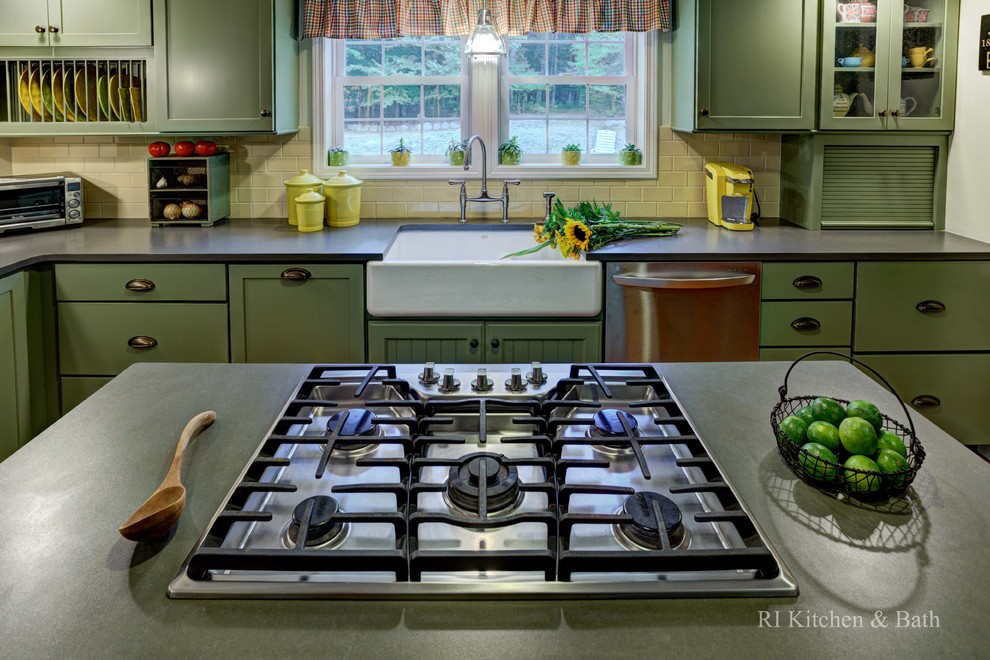 This is an example of a large country u-shaped eat-in kitchen in Providence with a farmhouse sink, shaker cabinets, green cabinets, granite benchtops, yellow splashback, ceramic splashback, stainless steel appliances, medium hardwood floors and with island.