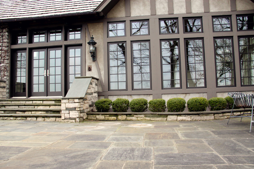 This is an example of a mid-sized traditional stucco beige exterior in Minneapolis.