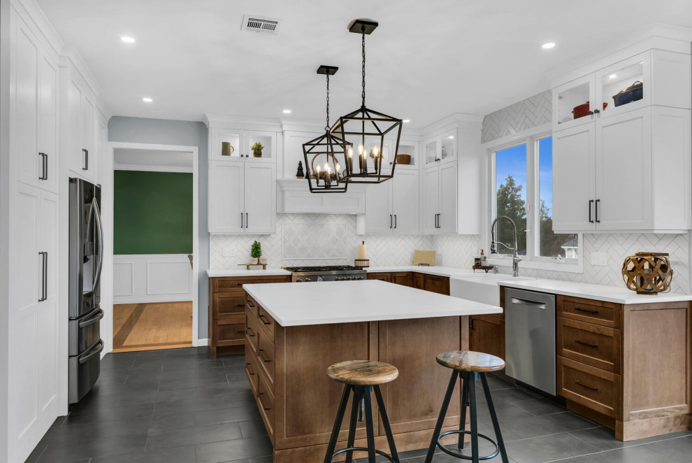 Inspiration for a medium sized traditional l-shaped kitchen/diner in New York with a submerged sink, flat-panel cabinets, white cabinets, engineered stone countertops, white splashback, ceramic splashback, stainless steel appliances, porcelain flooring, black floors and white worktops.