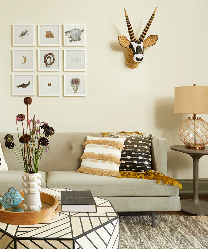 Inspiration for a small eclectic enclosed dark wood floor and brown floor living room library remodel in New York with beige walls, no fireplace and no tv