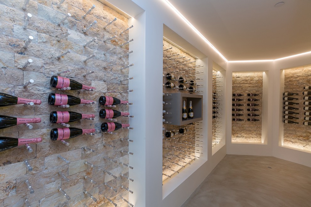 Photo of a contemporary wine cellar in San Diego with storage racks and beige floor.