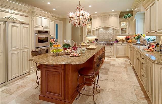 Photo of a traditional u-shaped separate kitchen in New York with a double-bowl sink, beaded inset cabinets, white cabinets, granite benchtops, white splashback, ceramic splashback, panelled appliances, linoleum floors and with island.