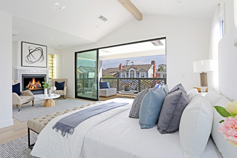 Inspiration for a beach style bedroom in Orange County with white walls, light hardwood floors, beige floor and vaulted.