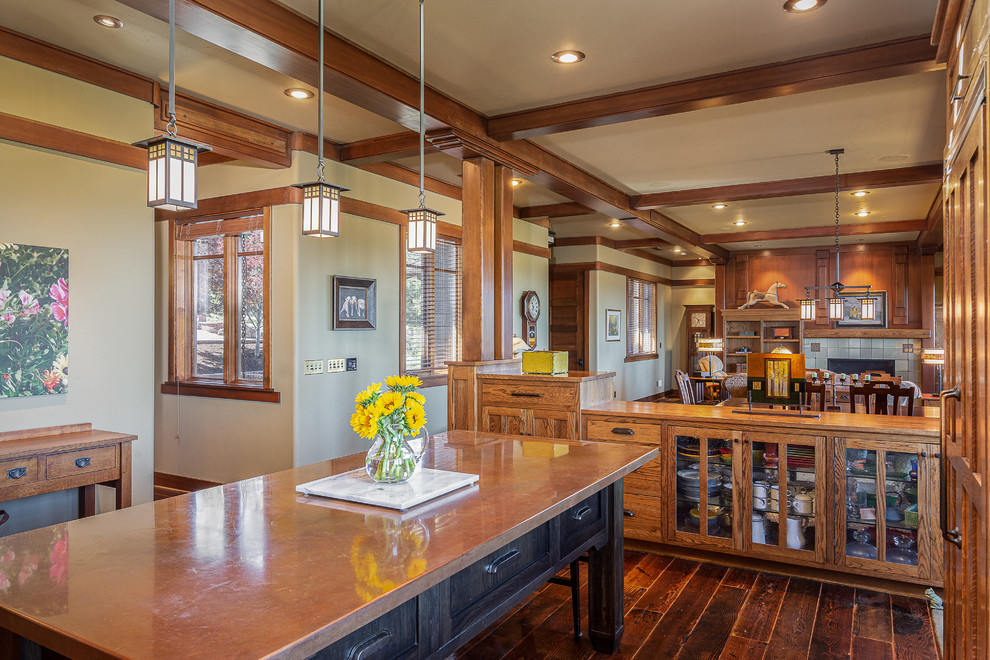 This is an example of an arts and crafts u-shaped kitchen in Other with shaker cabinets, medium wood cabinets, copper benchtops, dark hardwood floors, with island and brown floor.
