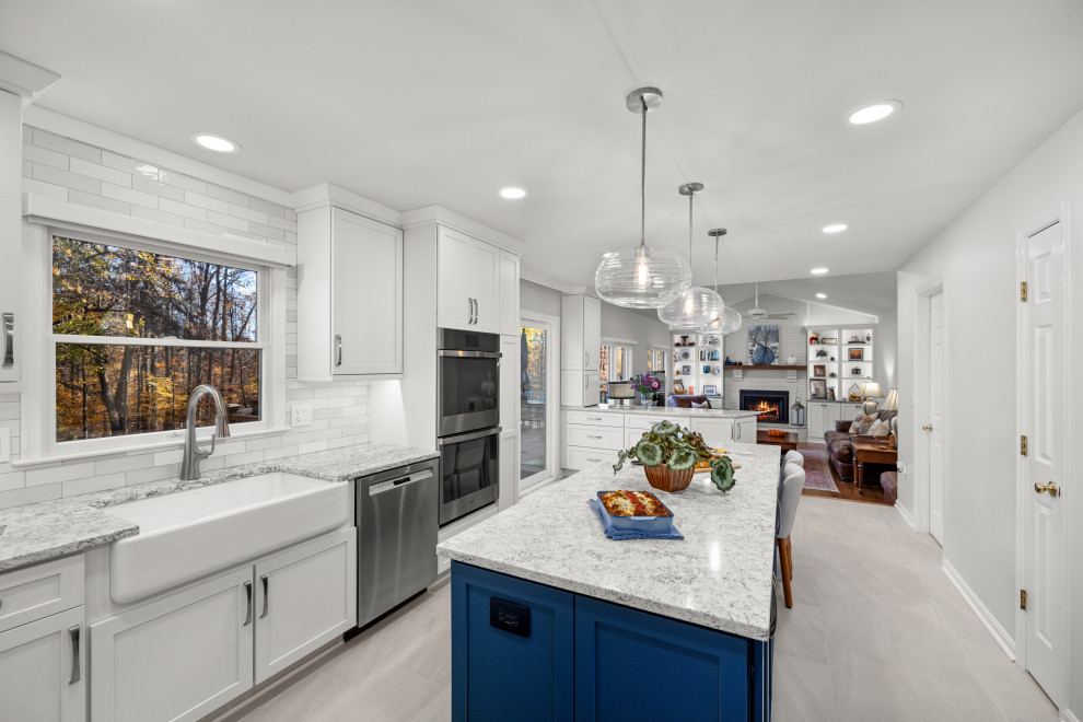 Design ideas for a mid-sized transitional kitchen in DC Metro with shaker cabinets, white cabinets, quartz benchtops, porcelain splashback, stainless steel appliances and with island.