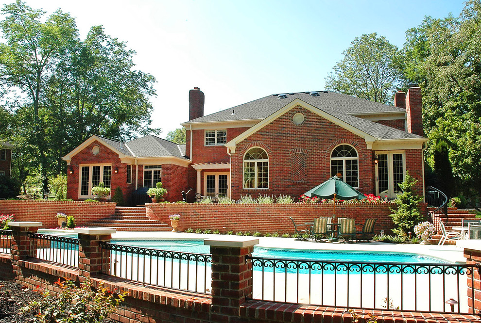 Inspiration for a large traditional two-storey brick red exterior in Cincinnati with a gable roof.