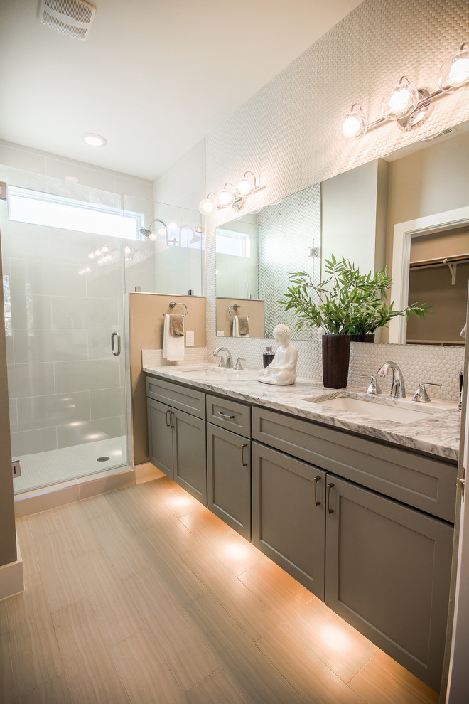 Design ideas for a mid-sized contemporary master bathroom in Austin with shaker cabinets, grey cabinets, a corner shower, a two-piece toilet, white tile, glass tile, multi-coloured walls, plywood floors, a drop-in sink and granite benchtops.