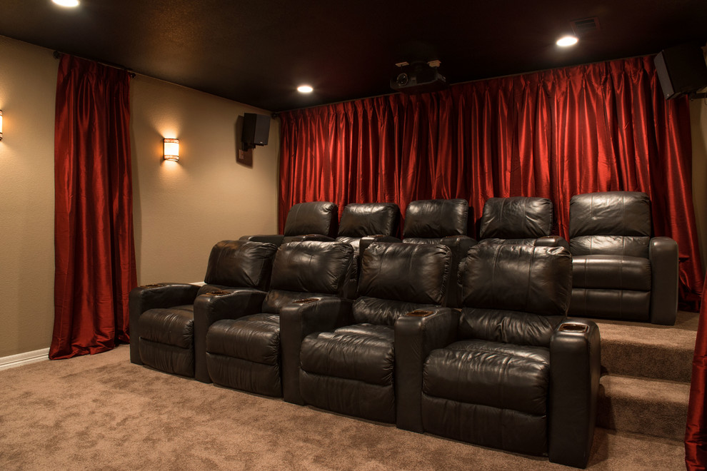 Large transitional home theatre in Denver with beige walls and carpet.
