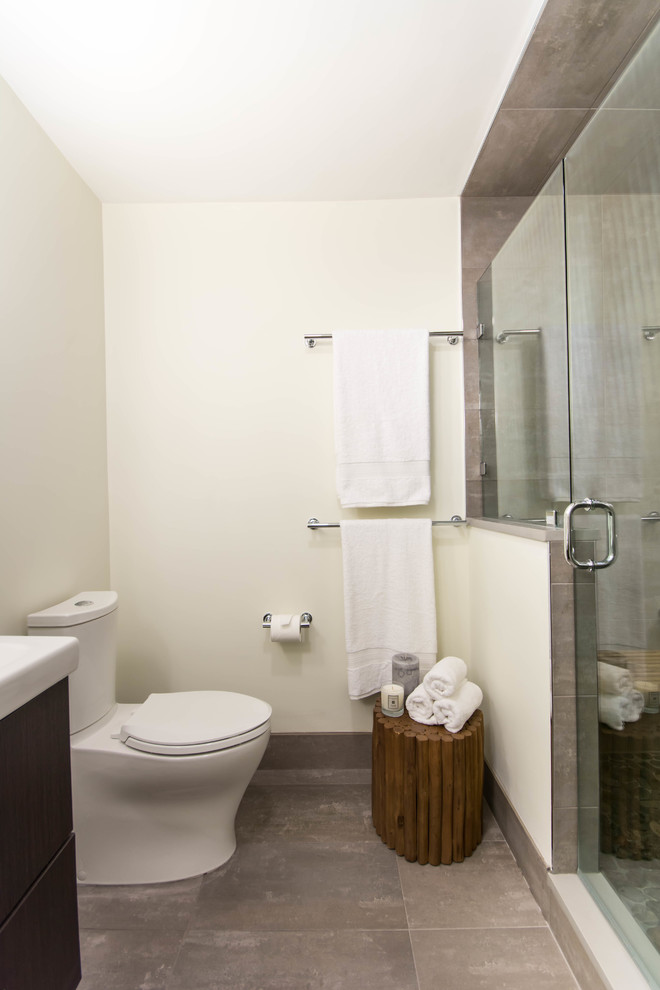 Design ideas for a mid-sized modern 3/4 bathroom in Providence with flat-panel cabinets, dark wood cabinets, an alcove shower, a one-piece toilet, gray tile, cement tile, white walls, slate floors, an integrated sink, engineered quartz benchtops, grey floor, a hinged shower door and white benchtops.