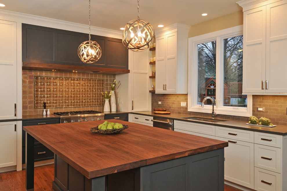 Eat-in kitchen - large transitional u-shaped medium tone wood floor eat-in kitchen idea in Chicago with an undermount sink, shaker cabinets, white cabinets, wood countertops, gray backsplash, stainless steel appliances, an island and stone tile backsplash