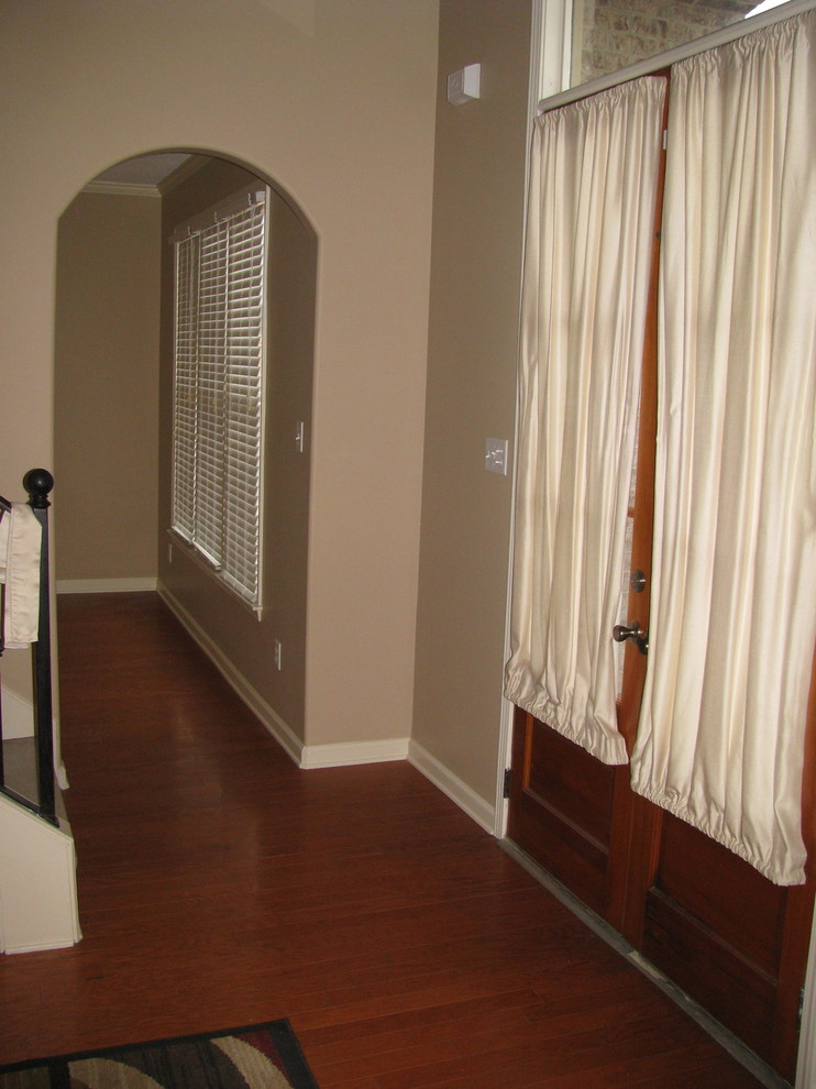 Photo of a mid-sized traditional hallway in Other with beige walls and medium hardwood floors.