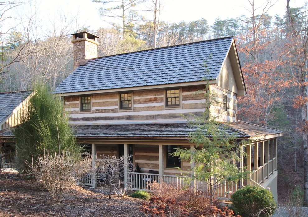 Inspiration for a mid-sized rustic gray two-story wood gable roof remodel