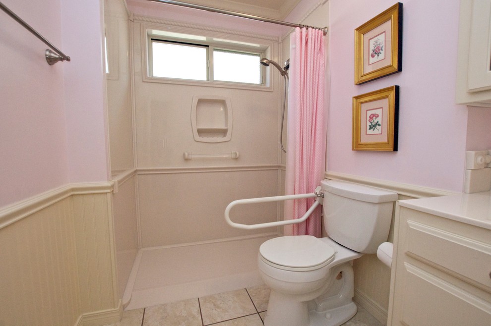 Photo of a traditional bathroom in Other with white cabinets, a curbless shower and porcelain tile.