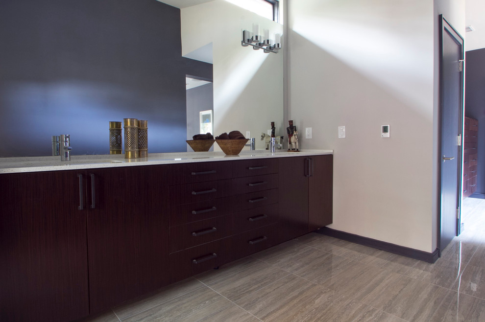 Photo of a large modern master bathroom in Atlanta with flat-panel cabinets, dark wood cabinets, multi-coloured walls, vinyl floors, an undermount sink and solid surface benchtops.