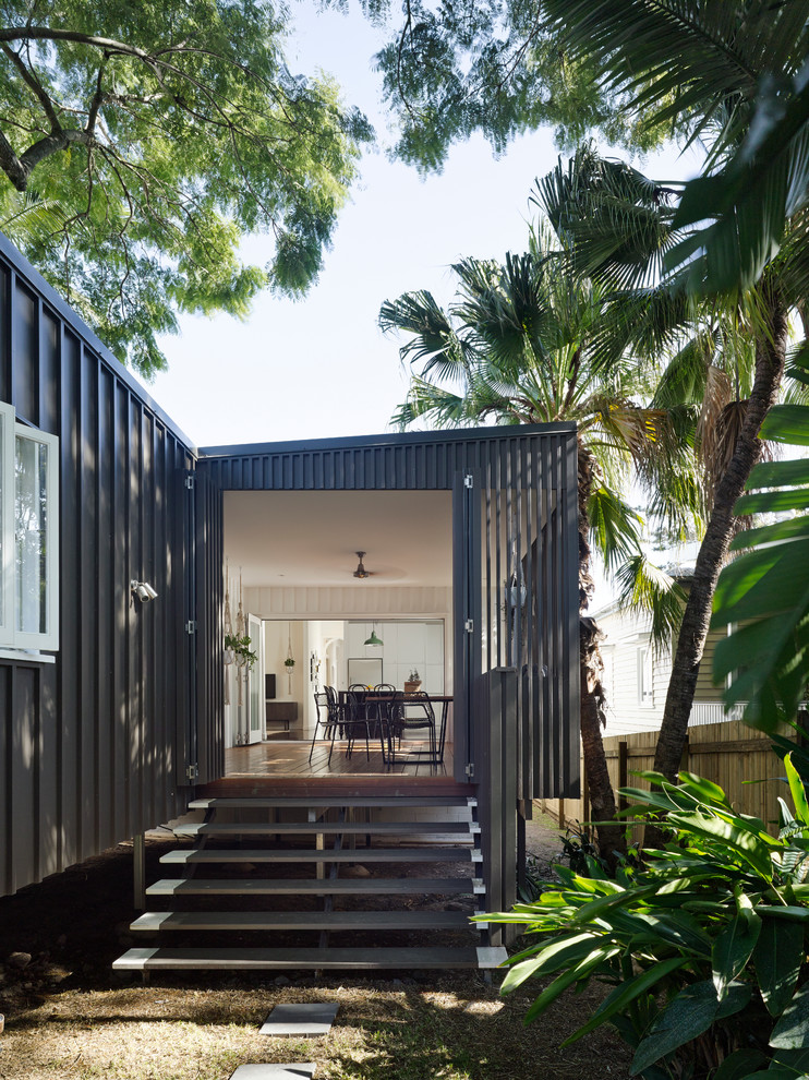 Photo of a contemporary one-storey black exterior in Brisbane with metal siding and a shed roof.