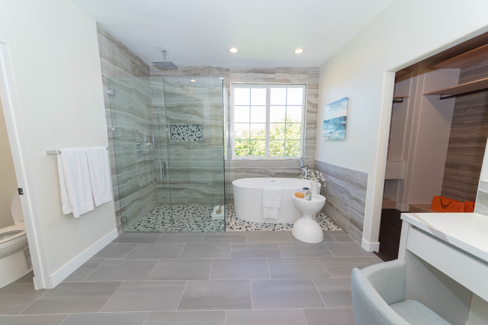 Inspiration for a large contemporary master bathroom in San Francisco with flat-panel cabinets, white cabinets, a freestanding tub, a corner shower, brown tile, porcelain tile, beige walls, porcelain floors, engineered quartz benchtops, a hinged shower door and grey floor.