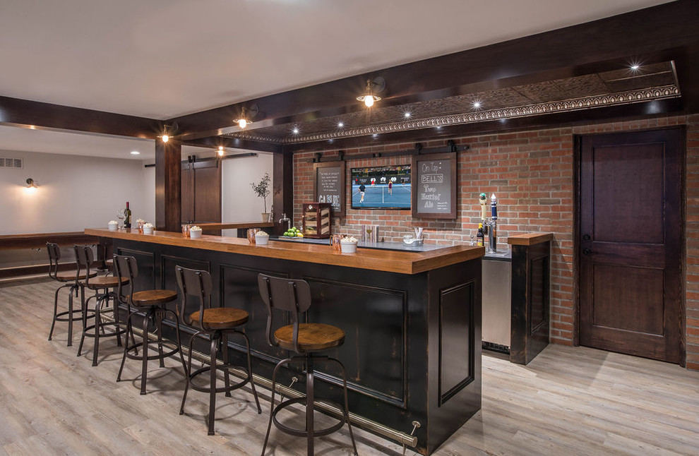Design ideas for a large industrial galley seated home bar in Detroit with vinyl floors, beige floor, an undermount sink, black cabinets, wood benchtops, red splashback, brick splashback and brown benchtop.