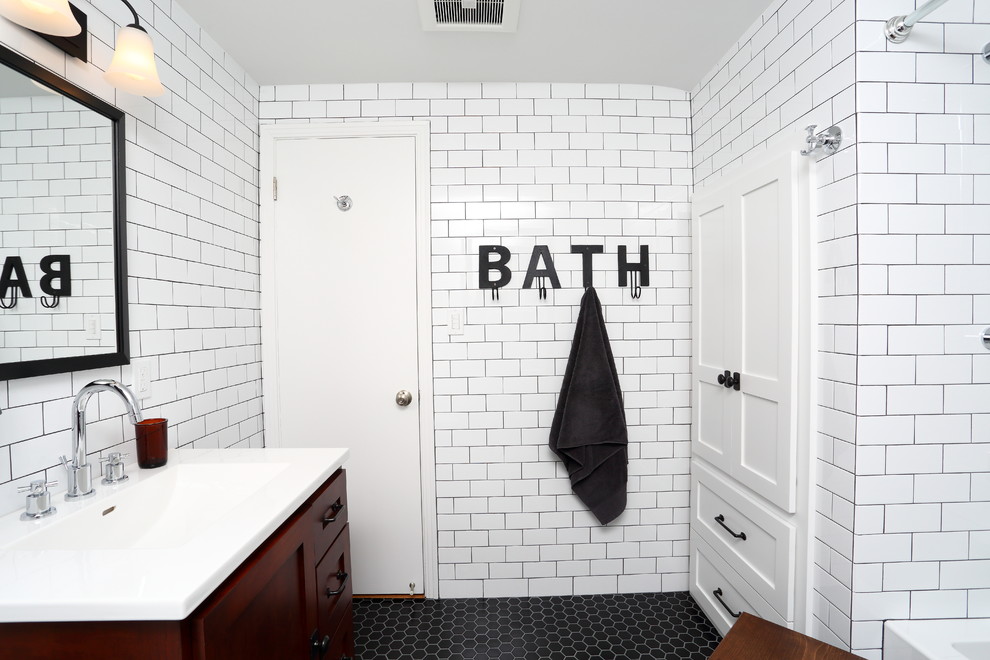 Design ideas for a mid-sized traditional master bathroom in Milwaukee with shaker cabinets, medium wood cabinets, an alcove tub, an alcove shower, a two-piece toilet, white tile, ceramic tile, white walls, ceramic floors, an undermount sink and marble benchtops.