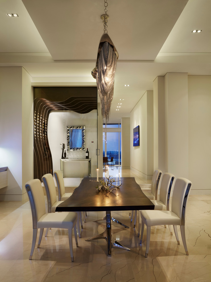 This is an example of an expansive contemporary open plan dining in Miami with beige walls and marble floors.