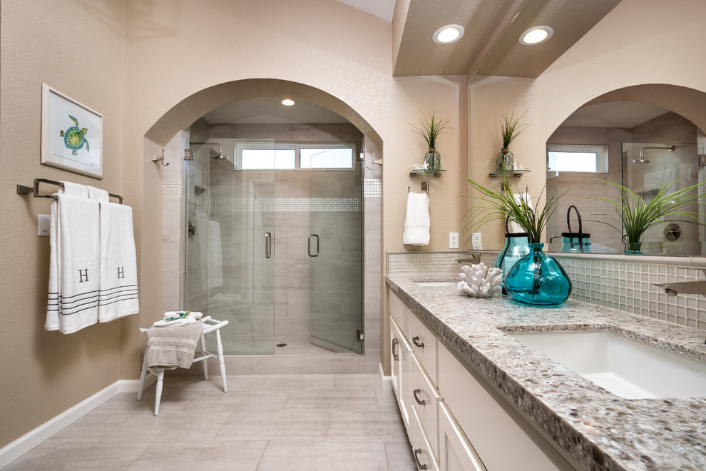Inspiration for a large beach style master bathroom in San Francisco with recessed-panel cabinets, white cabinets, beige walls and a drop-in sink.