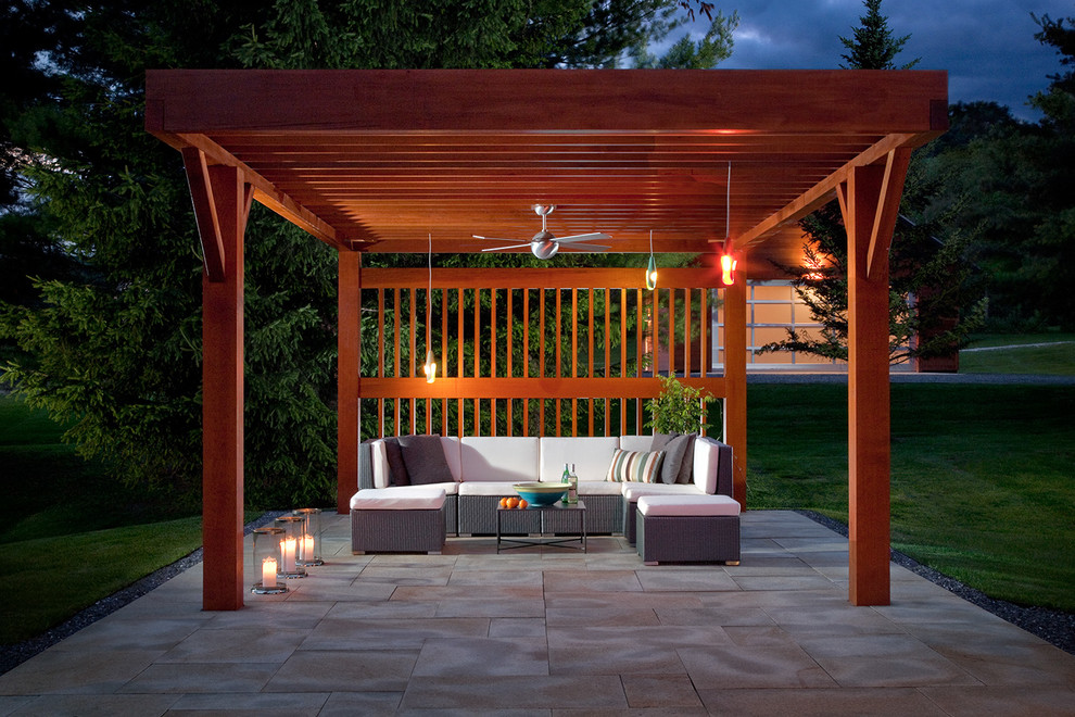 Small contemporary backyard patio in Bridgeport with natural stone pavers and a pergola.