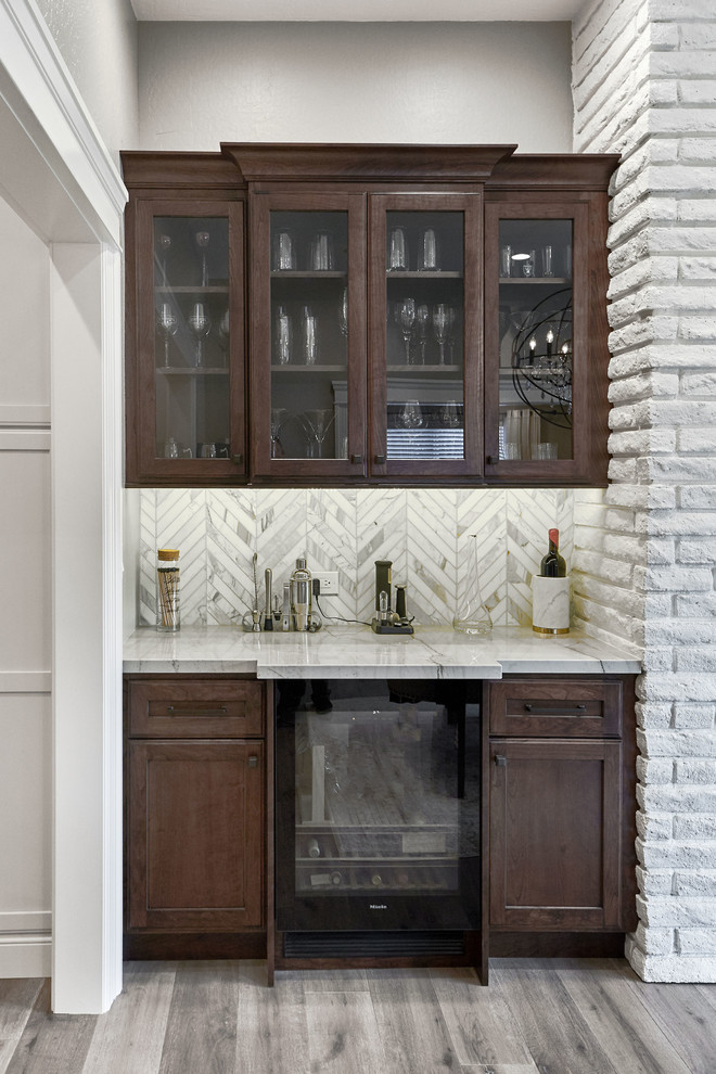 Design ideas for a small transitional single-wall wet bar in San Francisco with flat-panel cabinets, dark wood cabinets, quartzite benchtops, white splashback, marble splashback, light hardwood floors, grey floor and white benchtop.