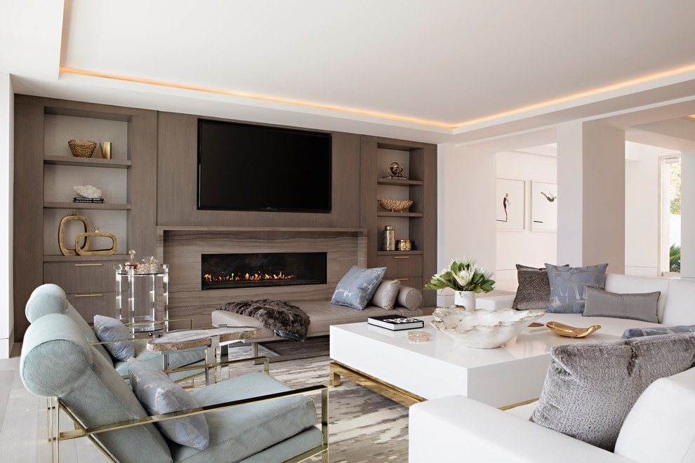 This is an example of a contemporary open concept living room in Orange County with white walls, a ribbon fireplace, a wall-mounted tv and white floor.