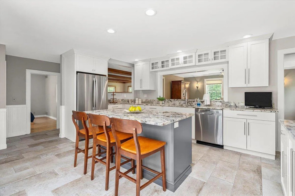 Inspiration for a large transitional u-shaped enclosed kitchen remodel in Boston with an undermount sink, shaker cabinets, white cabinets, granite countertops, stainless steel appliances, an island and gray countertops
