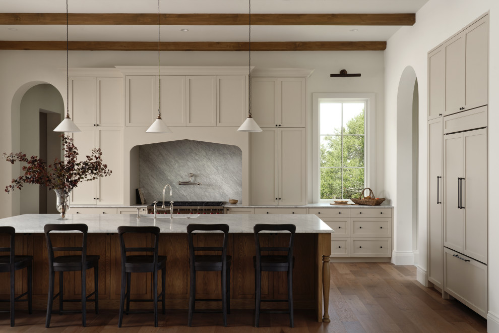 Transitional kitchen photo in Austin with marble countertops and marble backsplash