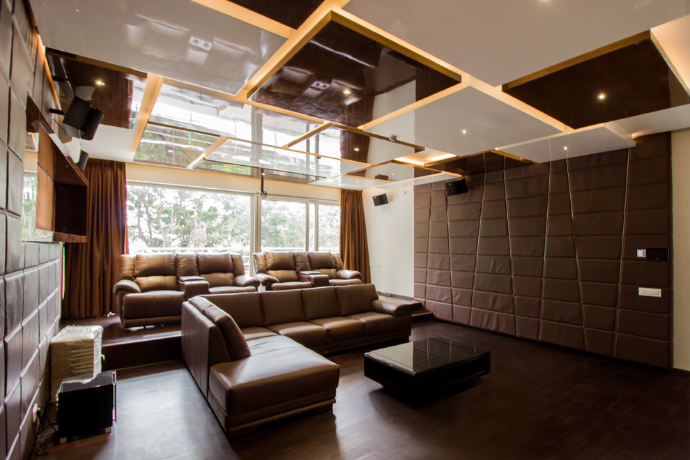 Großes, Abgetrenntes Modernes Heimkino mit weißer Wandfarbe, dunklem Holzboden und Leinwand in Sonstige