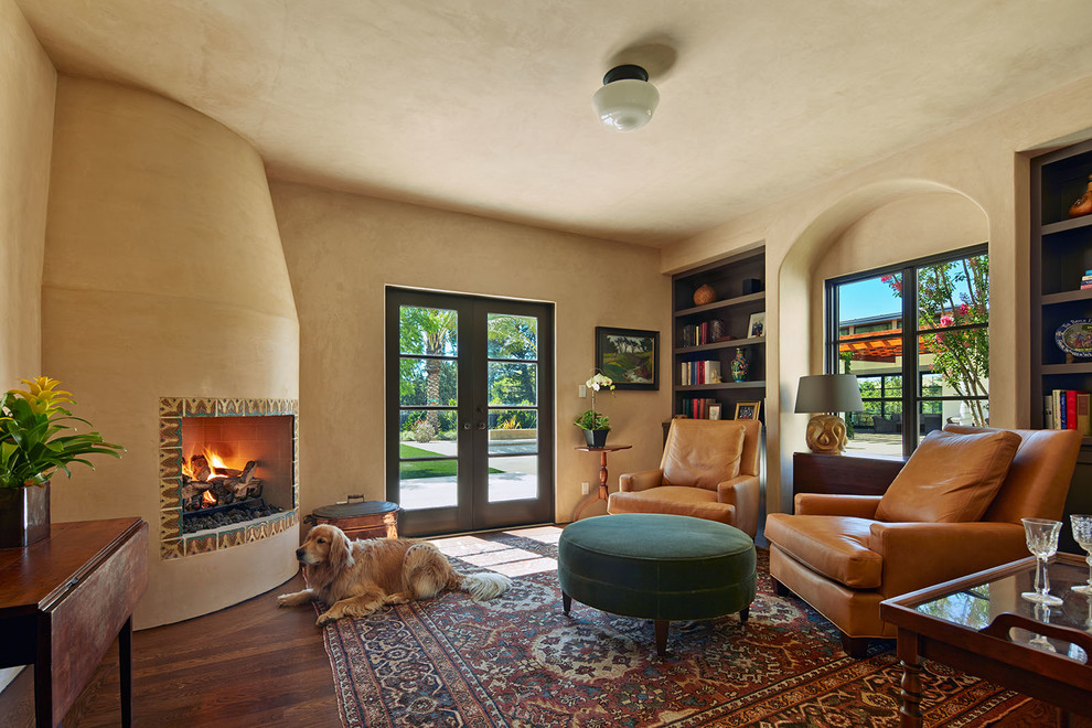 Photo of a mediterranean enclosed living room in San Francisco with beige walls, a corner fireplace, a tile fireplace surround and no tv.
