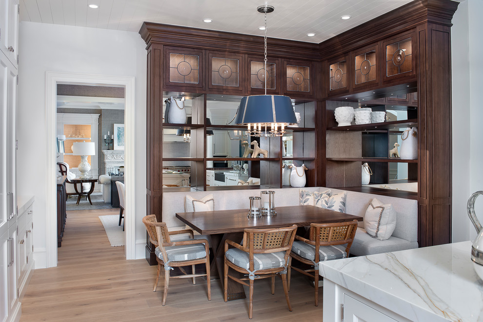 Inspiration for a beach style kitchen/dining combo in Cleveland with white walls and light hardwood floors.