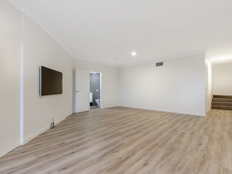 Inspiration for a mid-sized contemporary open concept living room in Brisbane with white walls, light hardwood floors and a wall-mounted tv.