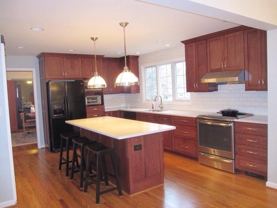 Inspiration for a large kitchen pantry remodel with recessed-panel cabinets and medium tone wood cabinets