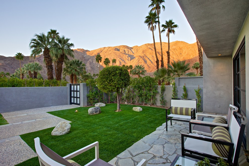 Inspiration for a contemporary patio in Los Angeles with natural stone pavers and no cover.